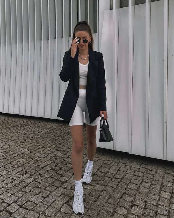 Black Blazer with White Crop Top + White Tight Shorts + Sneakers + Handbag + Sunglasses