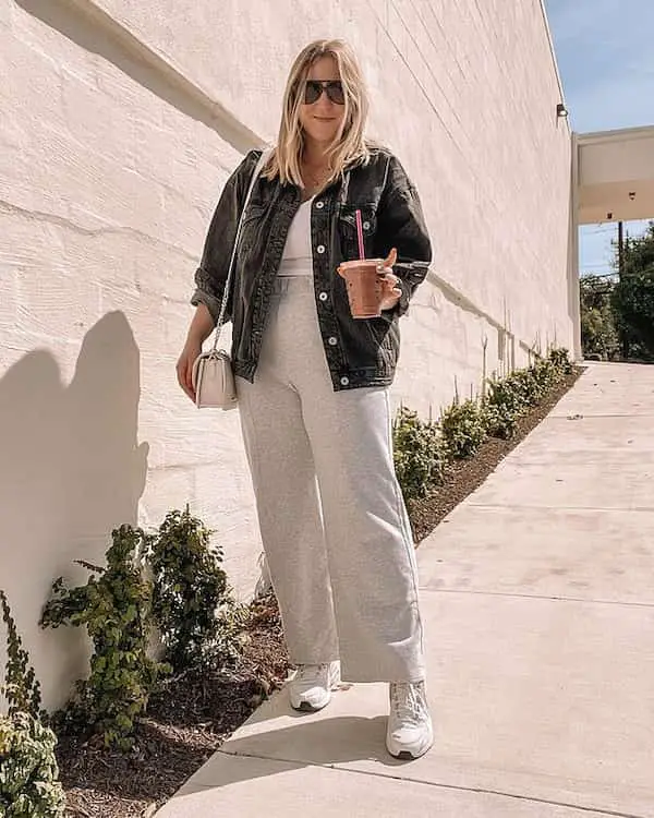 White Crop Top + Flared Gray Sweatpants + Denim Jacket + Sneakers + Chic Bag + Sunglasses