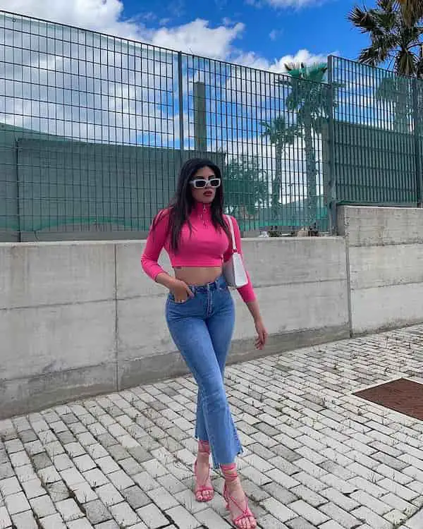 Pink Long Sleeve Crop Top with Flared Blue Jeans + Heels + Midi Handbag