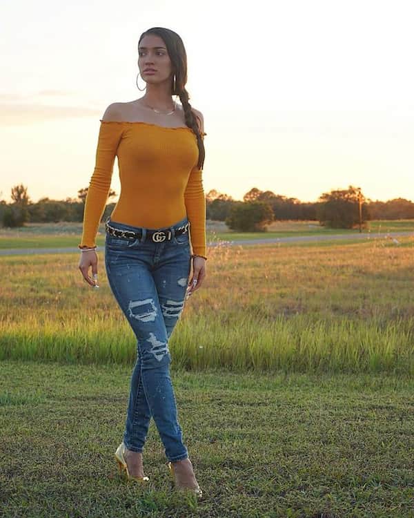 Up-Shoulder Yellow Top with Belt + Ripped Blue Jeans + Heels