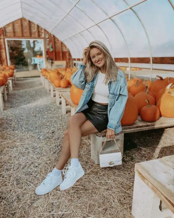 White Top with Oversized Denim Jacket + Leather Mini Skirt + Sneakers + Midi Handbag