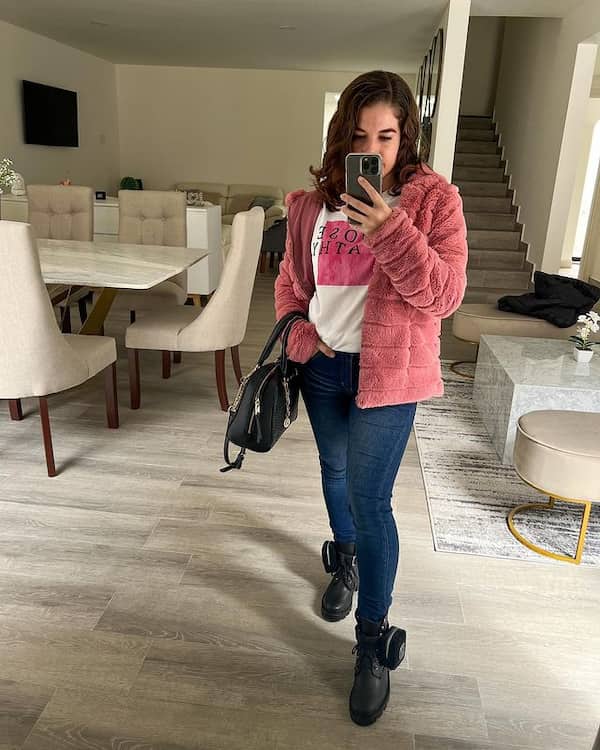 Black Combat Boots and Blue Jeans with White Graphic Shirt + Pink Jacket + Black Handbag