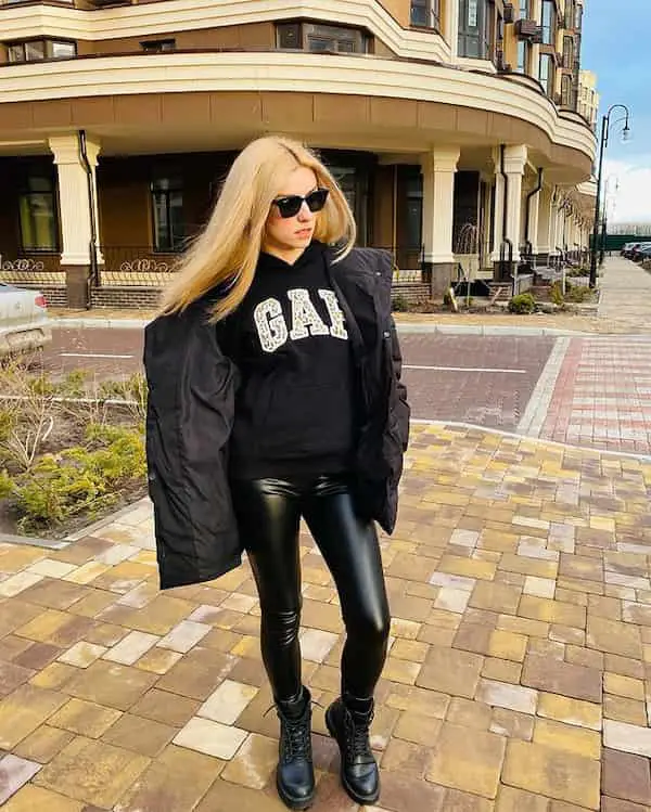 Black Combat Boots and Faux Leather Leggings with Black Graphic Top + Winter Jacket + Sunglasses