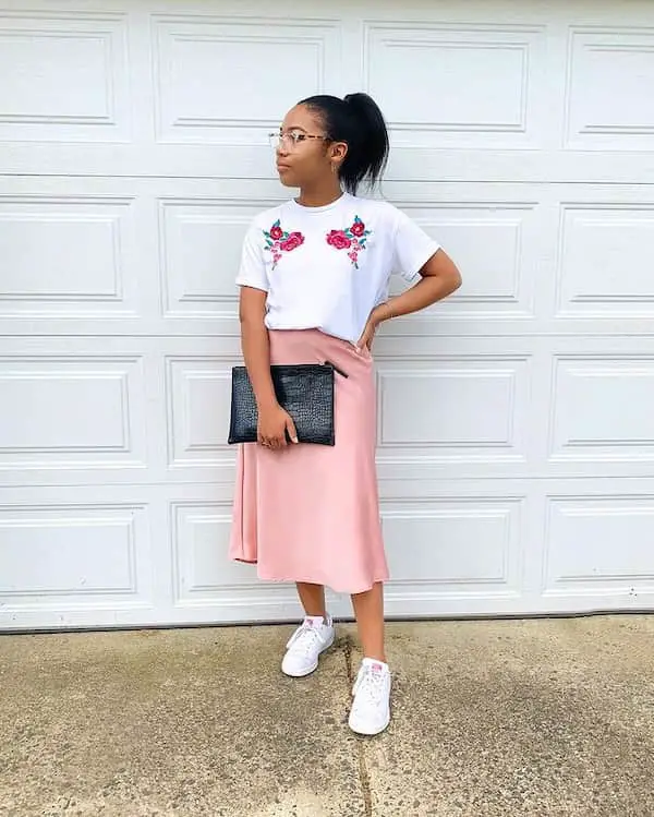 Pink Satin Skirt with White Graphic Shirt + White Sneakers + Black Clutch Purse + Sunglasses