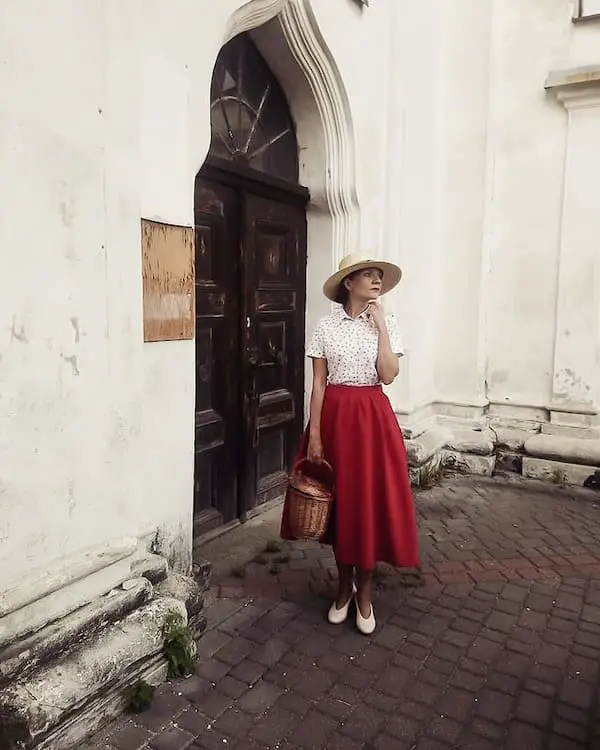 Red Maxi Pleated Skirt with White Floral Shirt + White Loafers + Neutral Colored Hat + Brown Basket Bag