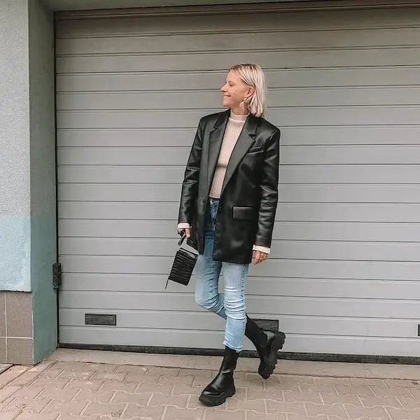 Blue Jeans with Brown Shirt + Black Oversized Leather Jacket + Boots + Clutch Purse